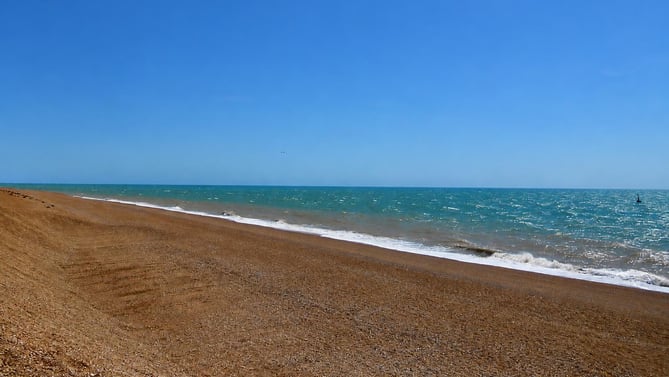 A shingle beach and blue sea on the Kent coast near New Romney