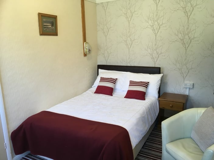 Room 11: ground-floor single room with a standard double bed and en-suite shower