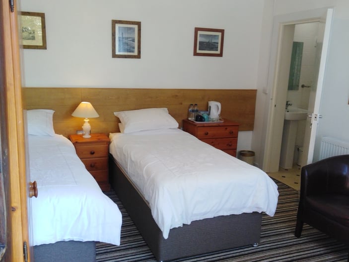 Room 12: ground-floor twin room with two standard single beds and en-suite shower