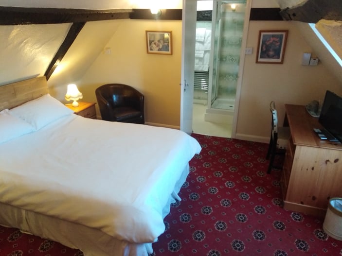 Room 8: second-floor room with a standard double bed and en-suite shower