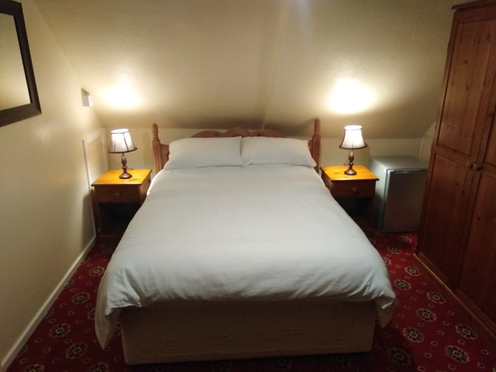 Room 9: second-floor room with a standard double bed and en-suite shower