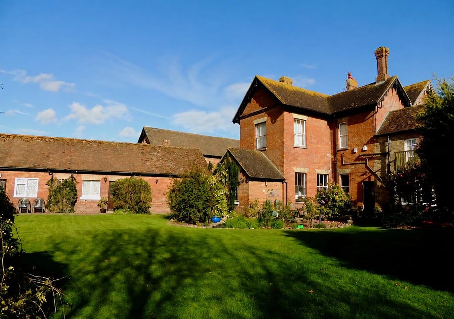The garden behind Broadacre, with the cottage rooms on the left and the back of the house on the right